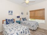 The nautical themed bedroom has two double beds 